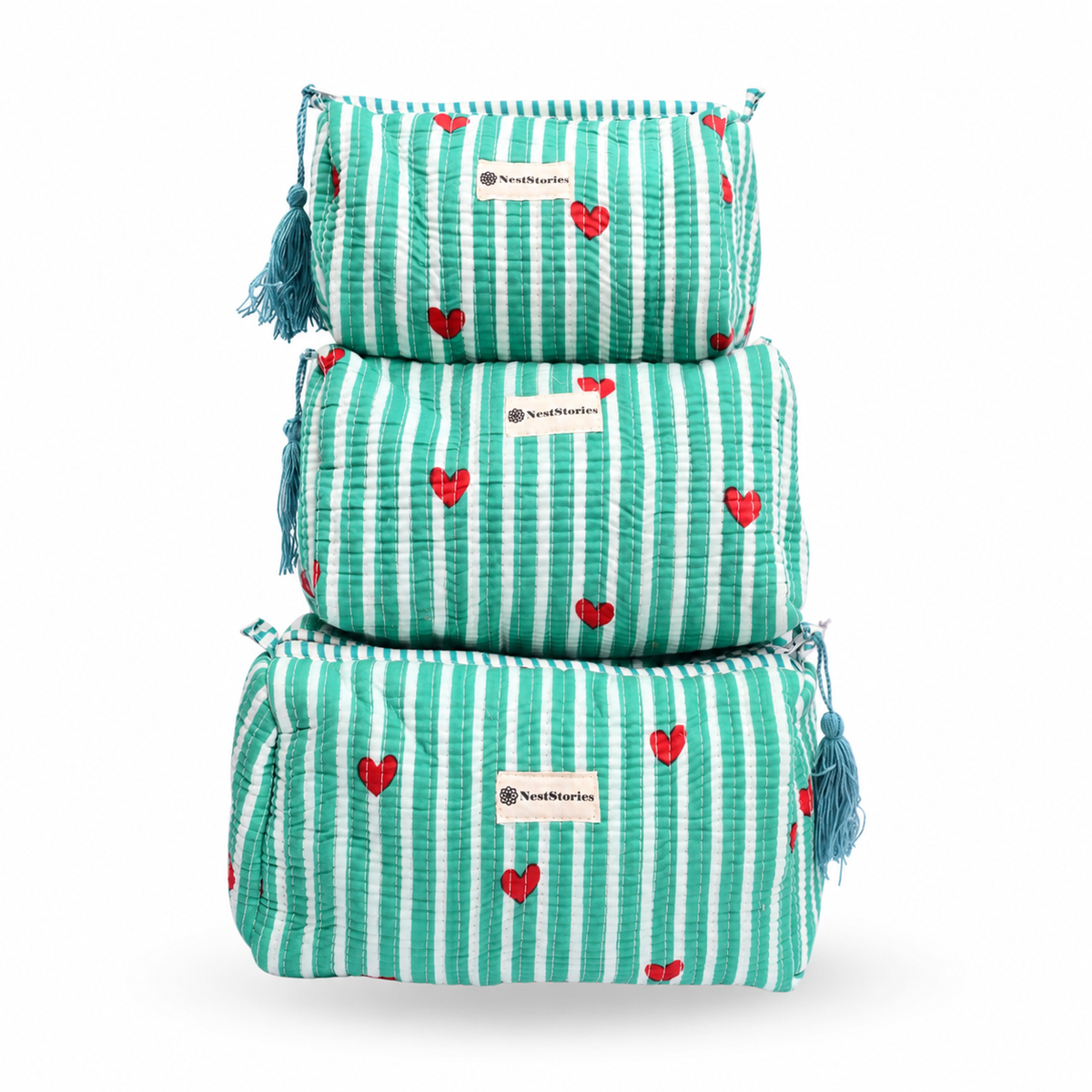 Three stacked makeup pouches in a tiered set, featuring a mint green and white striped pattern with small red hearts and blue tassels on the sides. Each pouch has a white label with the brand name 'TrendMarkets'.