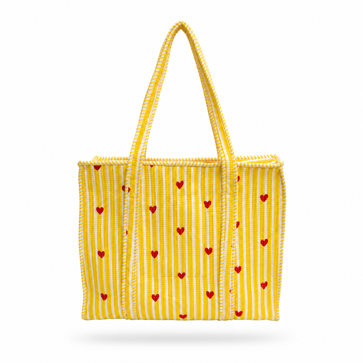A yellow woven tote bag with vertical white stripes and small red hearts, featuring two braided shoulder straps, shown against a plain white background.