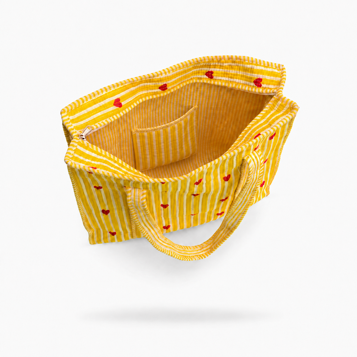 A yellow and white striped fabric tote bag with small red embroidered cherry motifs, shown floating against a light gray background.