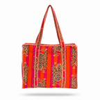 A woven tote bag featuring a vibrant pattern of orange, pink, and red stripes with black and beige tiger motifs, set against a plain white background.