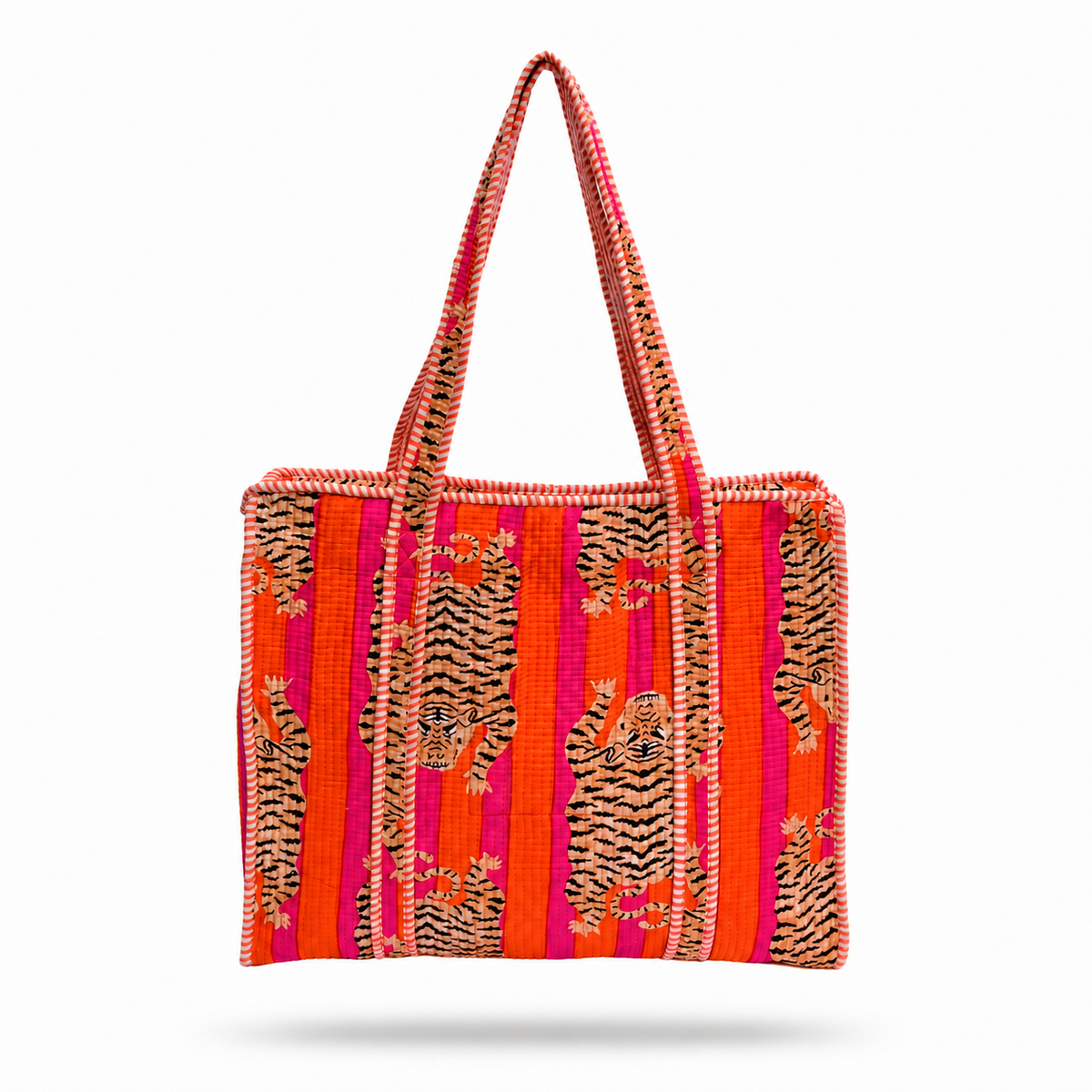 A woven tote bag featuring a vibrant pattern of orange, pink, and red stripes with black and beige tiger motifs, set against a plain white background.