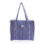 A navy blue and white vertically striped tote bag with small red hearts scattered across the front, featuring two shoulder straps and a small white brand label on the upper right side.