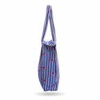 A fabric tote bag with a blue and white vertical stripe pattern and small red hearts, shown from the side on a white background.