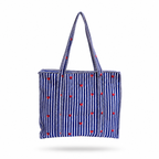 A blue and white vertically striped tote bag with small red polka dots, shown against a plain white background with a soft drop shadow.