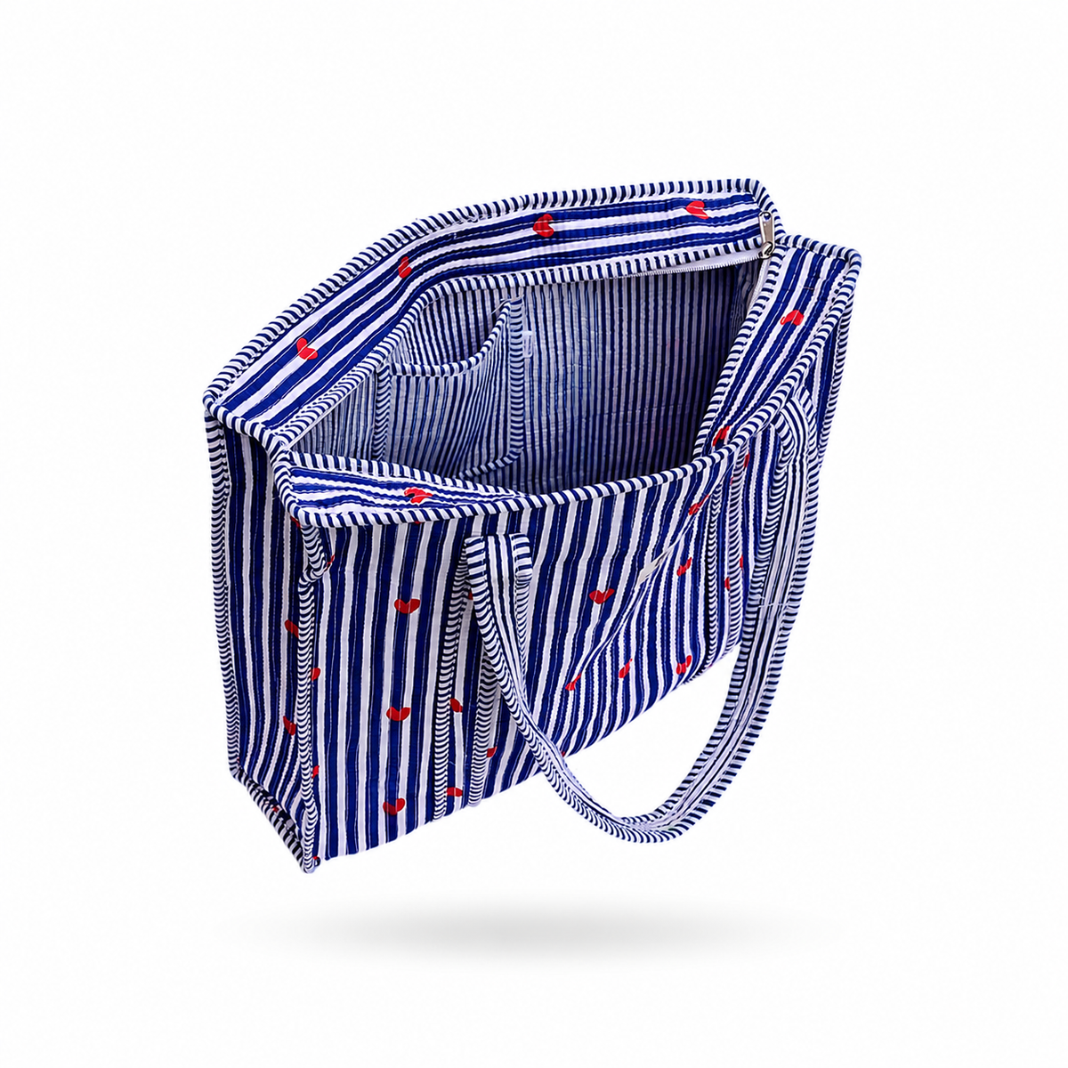 A fabric tote bag with a blue and white vertical stripe pattern and small red embroidered hearts, shown floating on a white background.