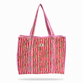 A pink and red striped tote bag with gold paisley patterns and pink-and-white braided shoulder straps, shown against a plain white background.