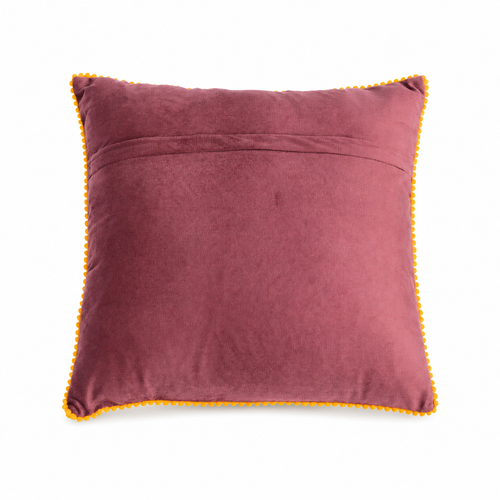The backside of a square throw pillow with a deep plum purple velvet background, featuring colorful embroidered flowers in pink, yellow, blue, and red with green leaves, finished with a yellow pom-pom trim.