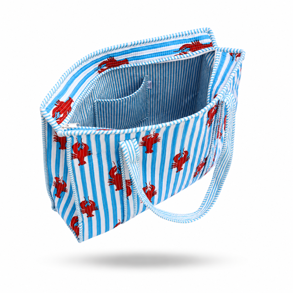 A fabric tote bag with a blue and white striped exterior patterned with red lobster motifs, featuring a matching blue and white striped interior and shoulder strap, shown on a white background.