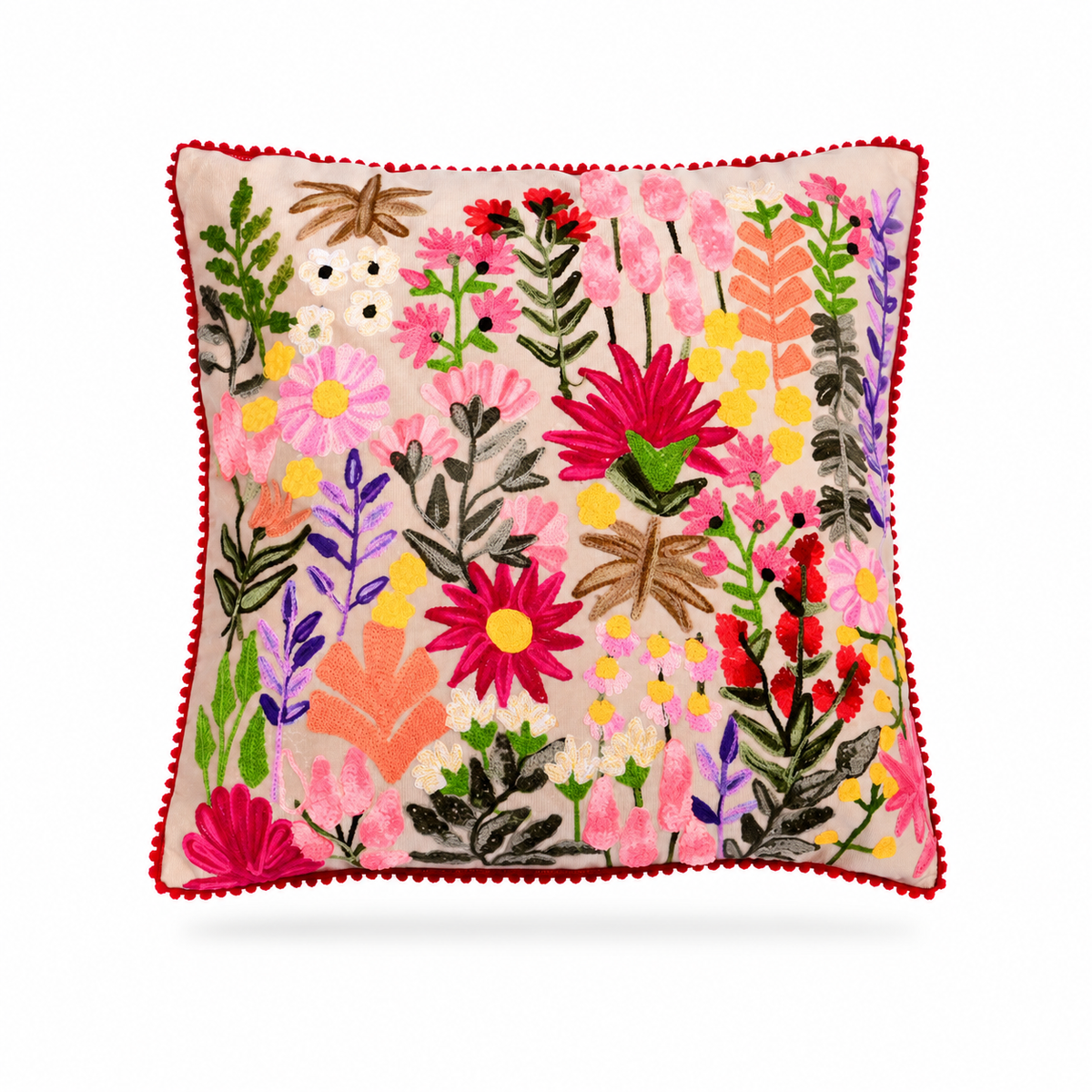 A square decorative throw pillow with a vibrant multicolor floral embroidery pattern on a light beige background, finished with a red pom-pom trim, shown against a plain white background.