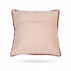 The backside of a square decorative throw pillow with a vibrant multicolor floral embroidery pattern on a light beige background, finished with a red pom-pom trim, shown against a plain white background.