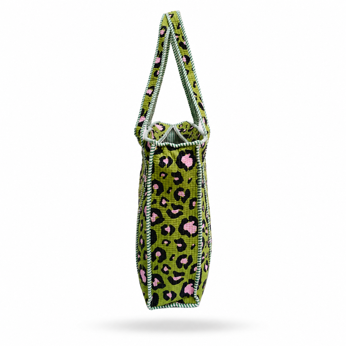 A vertical tote bag with a green, black, and pink leopard print pattern, featuring a light green and black zigzag stitched trim along the edges and handles, shown against a plain white background.
