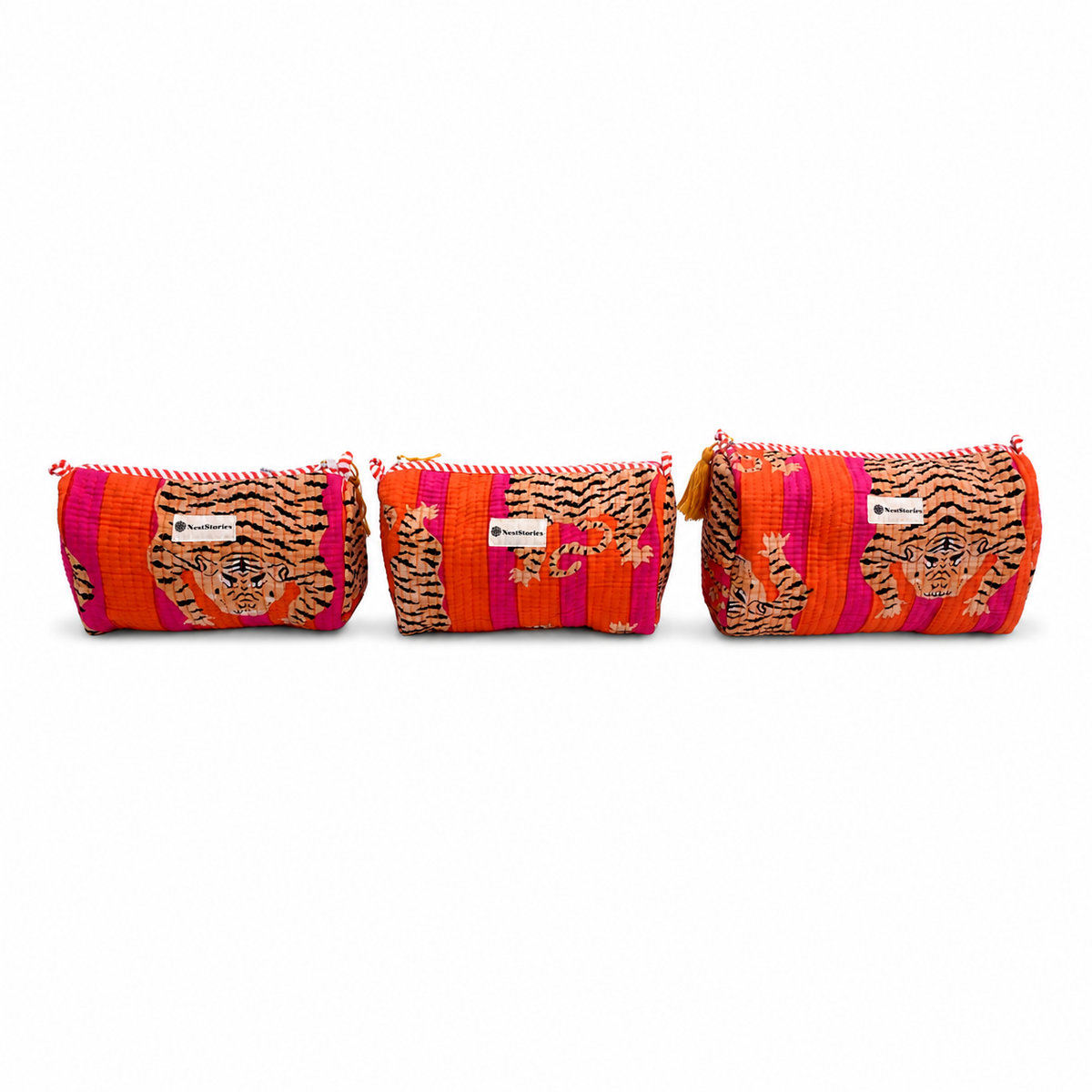 Three colorful zippered cosmetic pouches lined up on a white background. The pouches feature a vibrant pattern of orange, pink, and black tiger stripes with embroidered tiger faces.