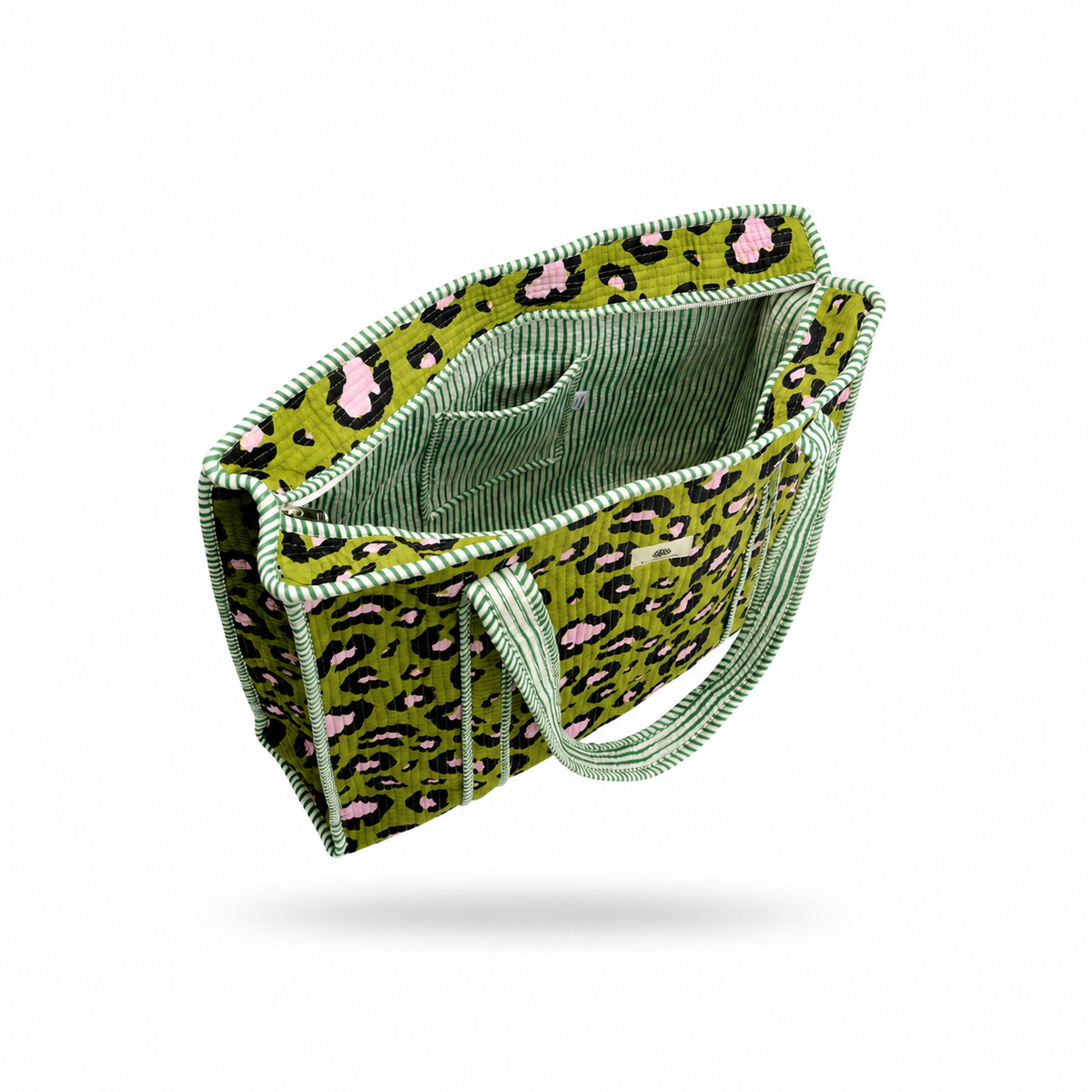 A green leopard print fabric tote bag with pink and black spots, featuring a striped green and white handle and trim, shown floating on a white background with a soft shadow underneath.
