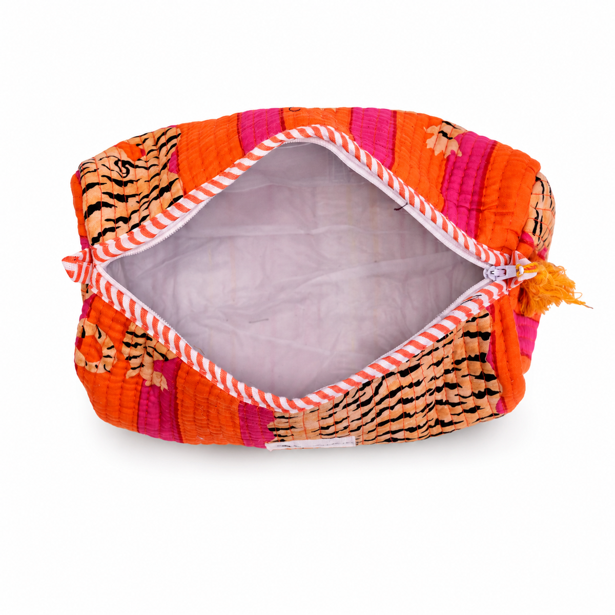 An open quilted cosmetic pouch with a vibrant orange, pink, and tiger-print pattern, featuring a striped zipper and a small orange tassel, shown on a white background.
