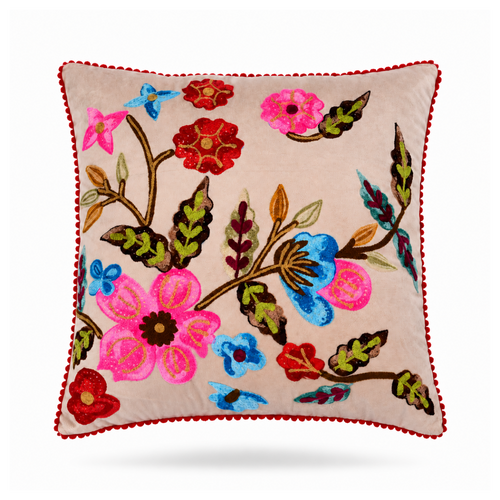 A square decorative throw pillow with a beige background and colorful floral embroidery, finished with a red pom-pom trim, shown on a white background.