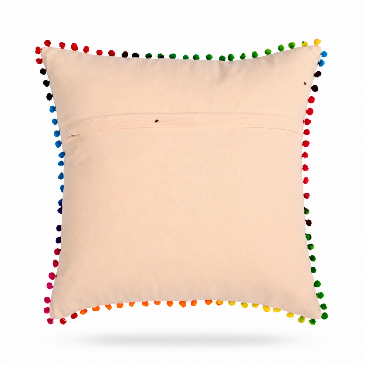 back of a square beige throw pillow featuring a colorful embroidered toucan holding a bouquet of flowers, finished with a border of multicolored pom-poms, shown on a white background.