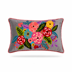 A rectangular gray throw pillow with a colorful embroidered floral pattern in the center and a red pom-pom trim around the edges, shown on a white background.