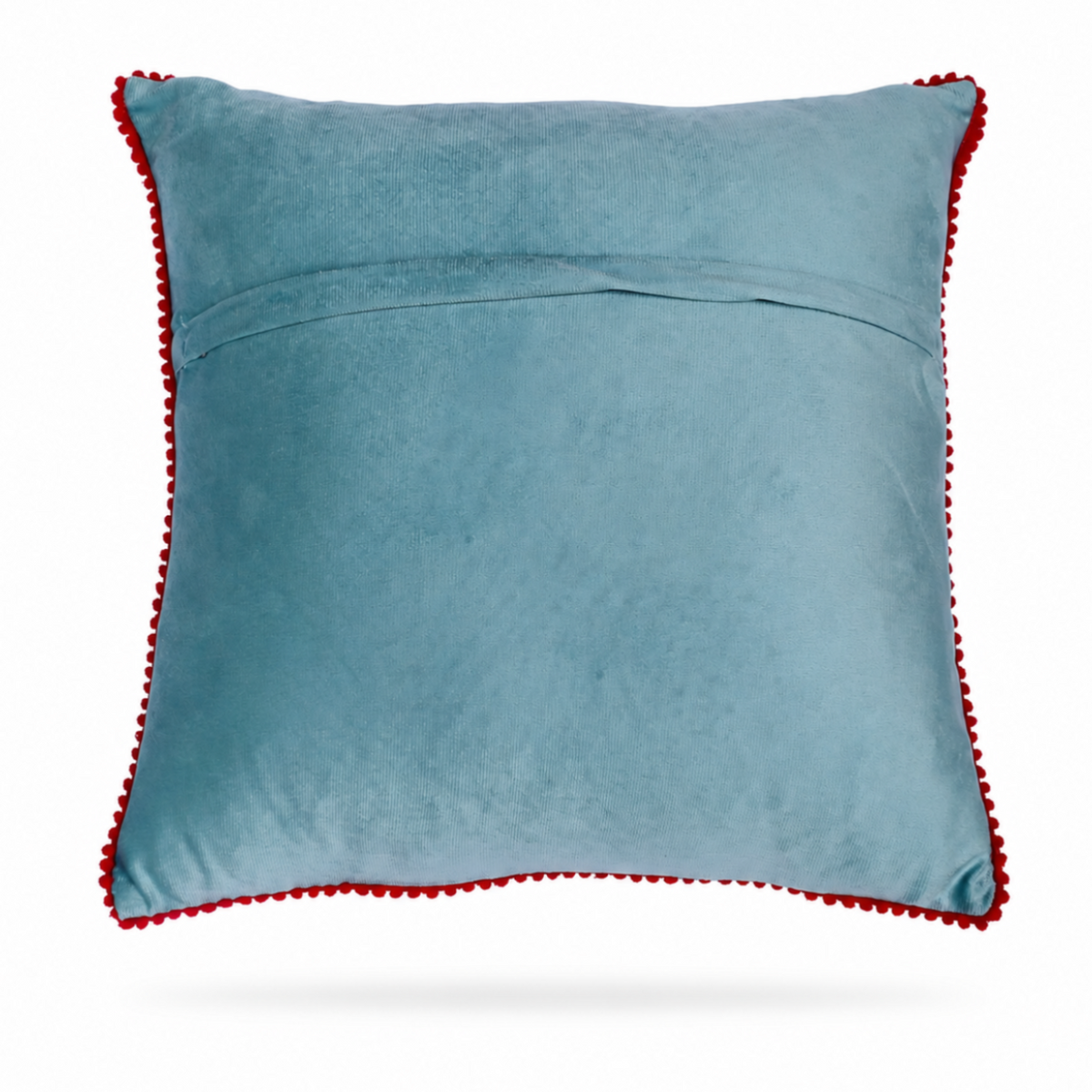 the backside of a square light blue throw pillow with a colorful embroidered floral pattern in the center and a red pom-pom trim around the edges, shown on a light blue background.