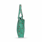 A green canvas tote bag with white vertical stripes, small red hearts, and white stitched edges, shown from a side profile view on a white background.