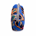 A small zippered pouch with a vibrant blue and orange ikat pattern, featuring a black and white striped zipper, shown on a plain white background.