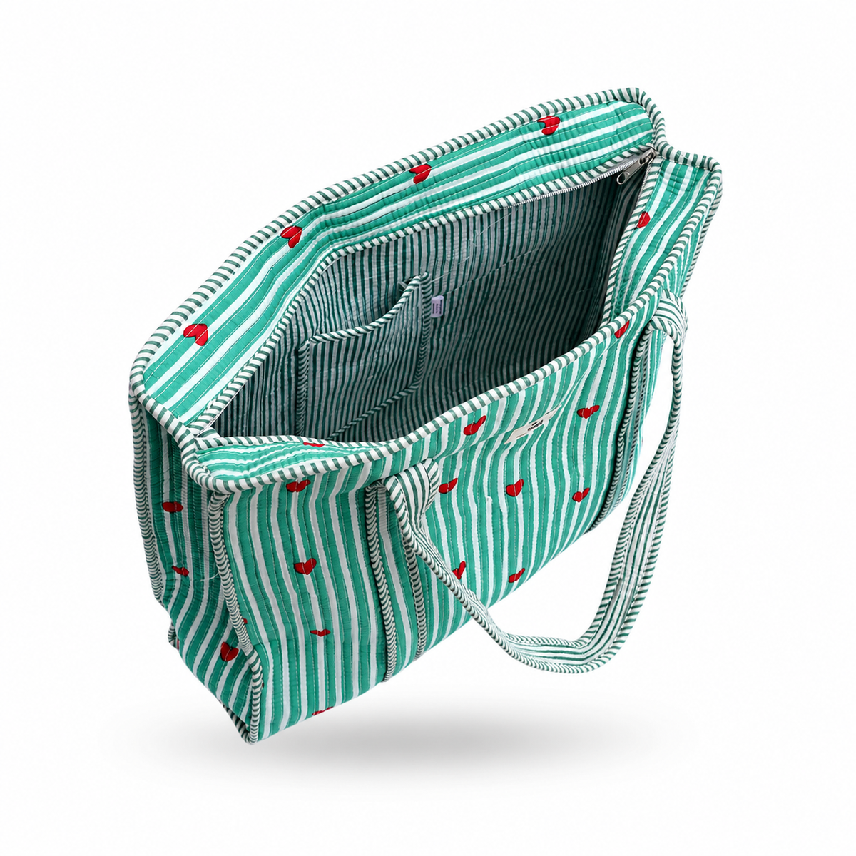 A striped tote bag with a green and white pattern, accented with small red hearts, shown open to reveal its interior design against a white background.