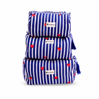 Three stacked reusable cloth pouches with a blue and white vertical stripe pattern and small red heart prints. Each pouch has a white fabric label with the brand name 'NewMeasures' and a blue tassel on the side.