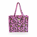 A pink woven tote bag with a black and lime green leopard print pattern, featuring two top handles and a small white logo on the front.