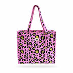 A pink woven tote bag with a black and lime green leopard print pattern, featuring two top handles and a small white logo on the front.
