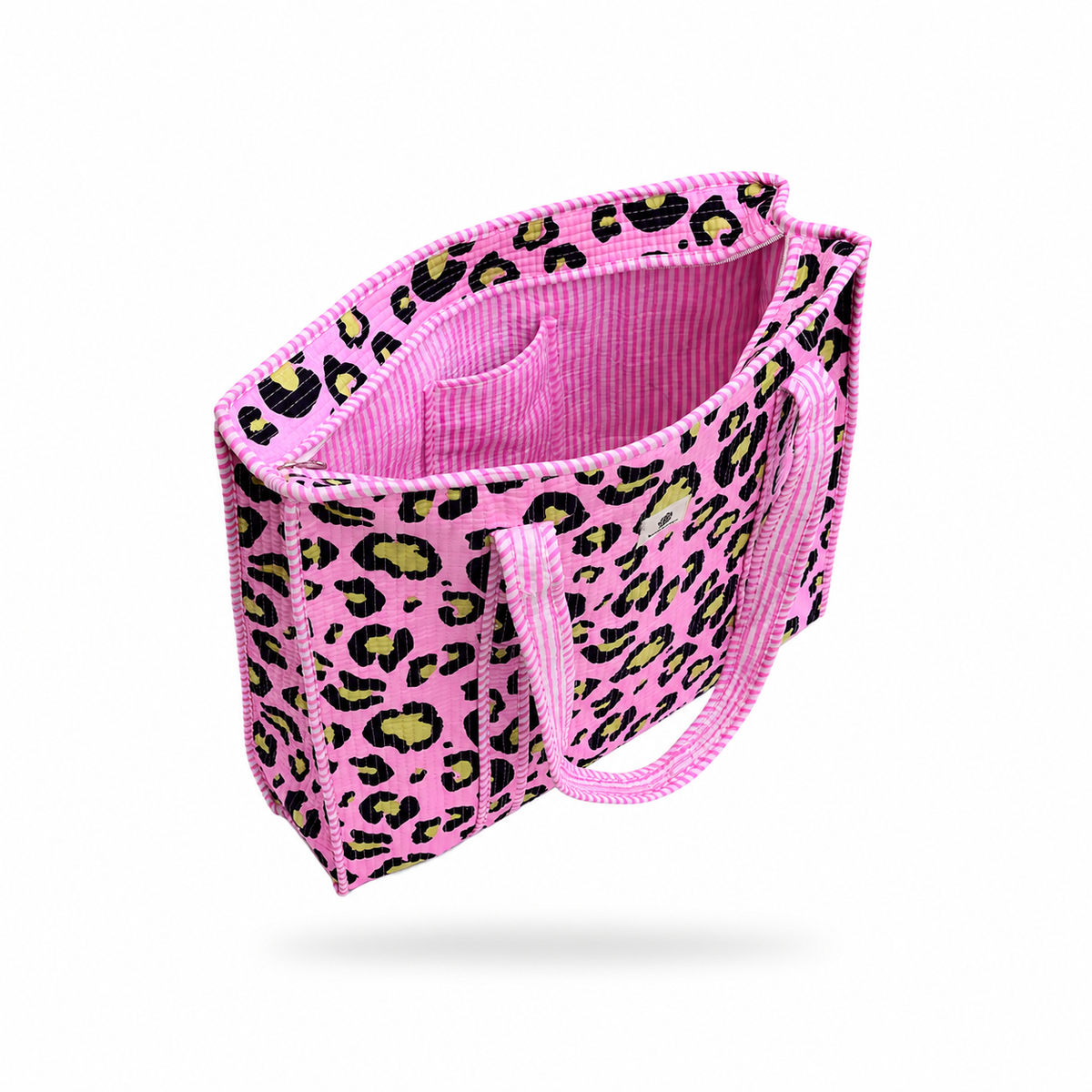 A pink tote bag with a black and lime green leopard print pattern, featuring a pink ribbed fabric interior and matching pink handles, shown floating against a white background.