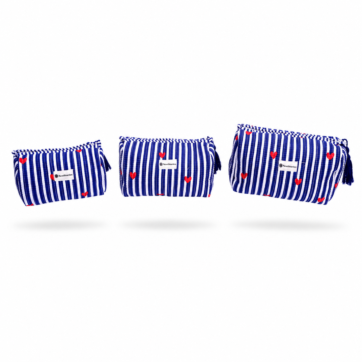 Three small zip pouches in matching blue and white vertical stripes with small red heart prints, shown on a clean white background.