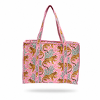 A pink woven tote bag featuring an allover print of golden leopards and green foliage, with pink and white striped handles, shown against a plain white background.