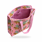 A pink woven tote bag with a leopard and tree pattern, featuring a pink and white striped interior and matching striped handles, shown on a pink white background.