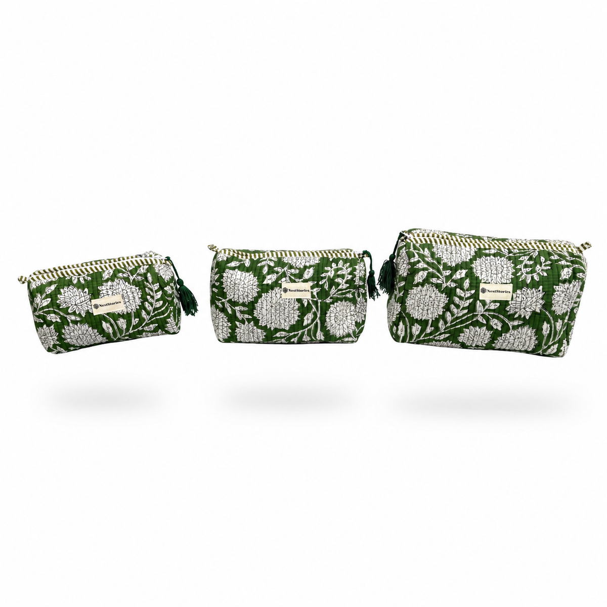 Three woven clutch bags in a matching  pattern flowers on a green background, displayed in ascending sizes.