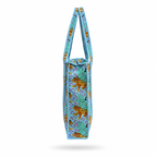 A Tote bag featuring a pattern of golden leopards on a turquoise and purple background, with light blue braided shoulder straps, shown against a plain blue purple background. 