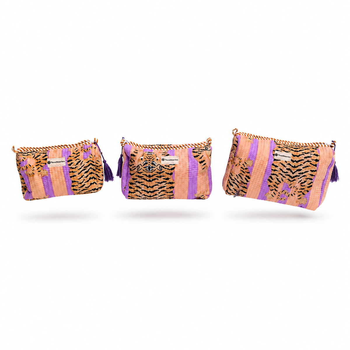 Three woven clutch bags in a matching tiger-and-purple pattern, displayed in ascending sizes against a plain white background.