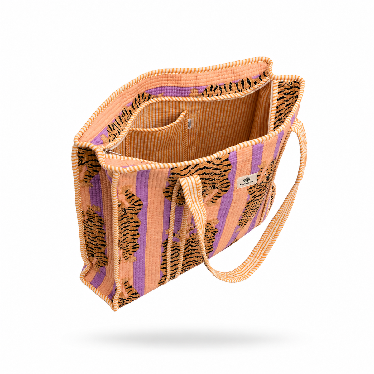 A woven tote bag with a pattern of purple vertical stripes, black tiger-like spots, and a tan interior, shown floating against a white background.